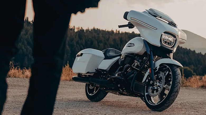 White 2025 Harley-Davidson Street glide parked on gravel road with mountains and trees in background