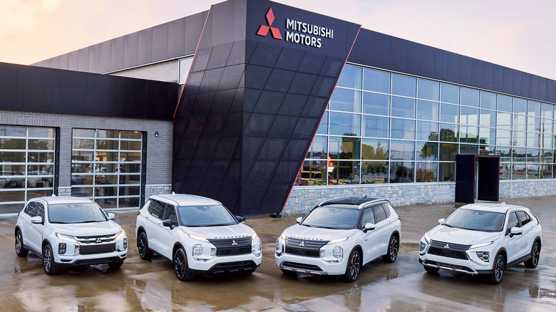Mitsubishi's 2025 model year car lineup parked in front of dealership