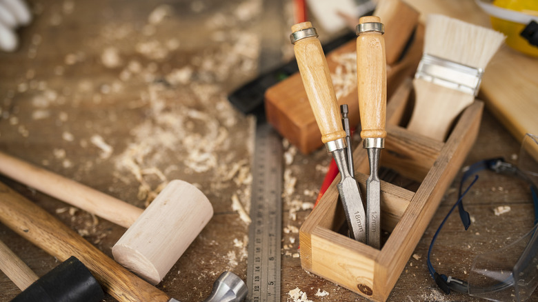 Woodworking tools on a table covered in wood shavings