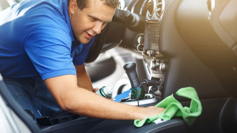 Man cleaning car with wet vac