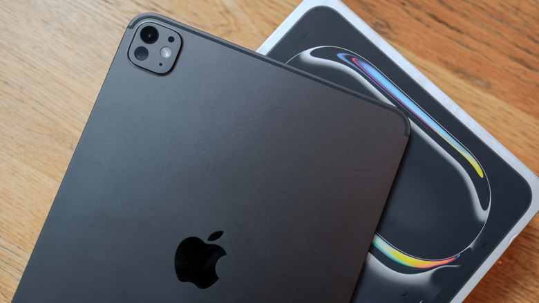 A black iPad Pro sitting on top of its box