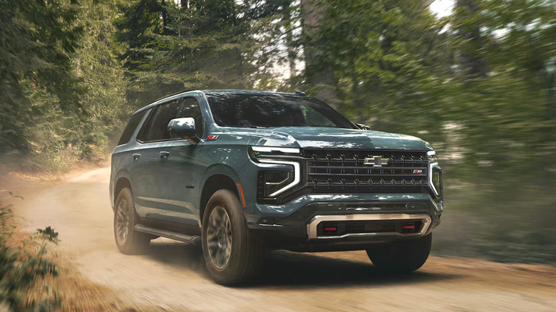 Chevy Tahoe driving down a dirt road