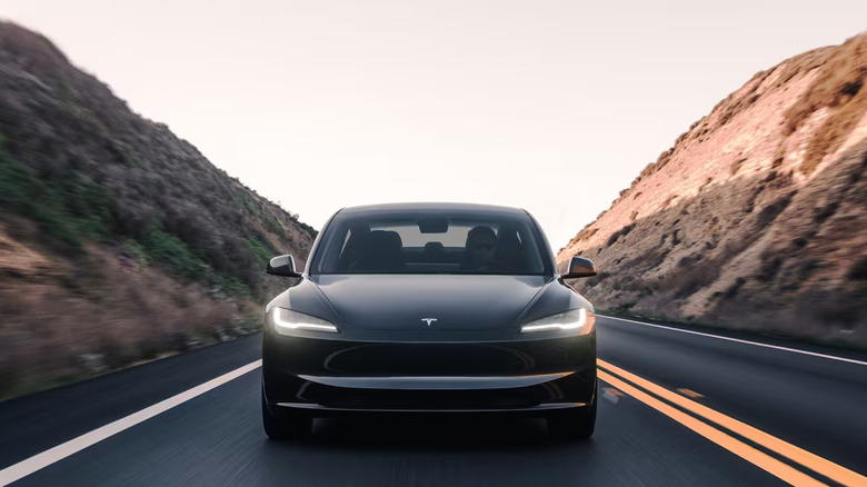 Front shot of a black Tesla Model 3 driving