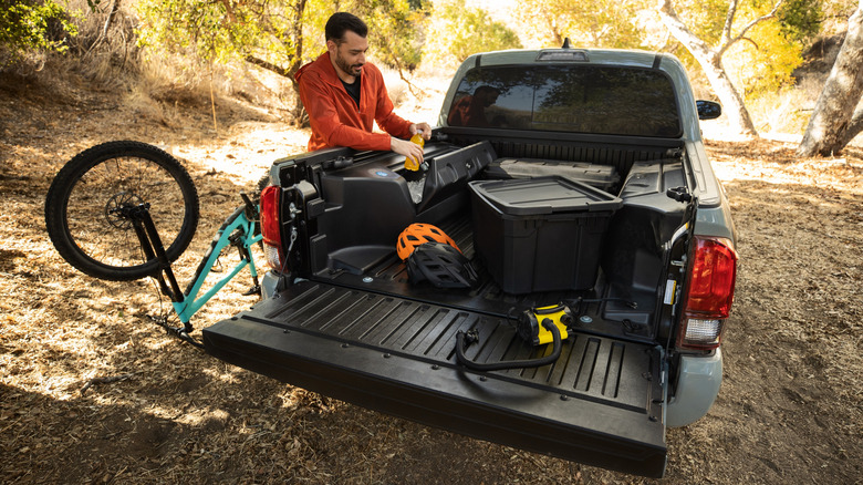 Rear of 2022 Toyota Tacoma with bike and gearboxes loaded in truck bed