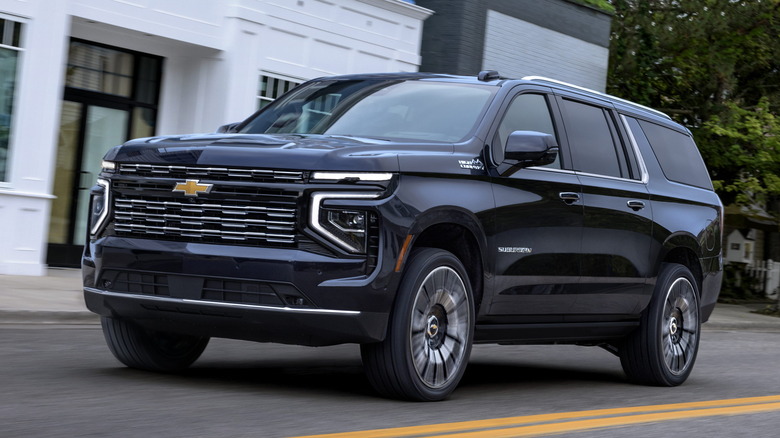 Front 3/4 view of 2025 Chevrolet Suburban in small town setting