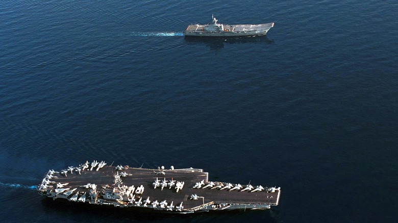Chakri Naruebet (top) underway with the United States Navy supercarrier USS Kitty Hawk