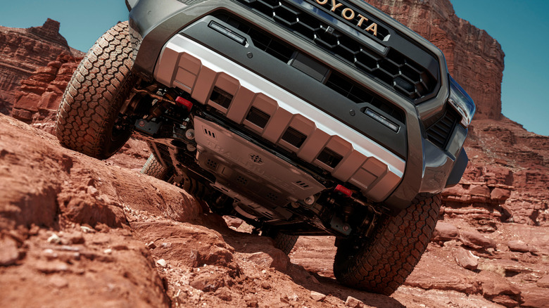 Underside and front tires of a 2025 Toyota Tacoma Trailhunter on a cliff