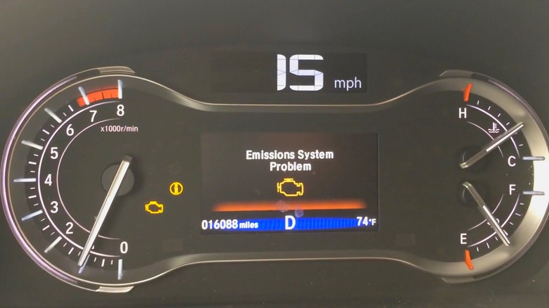 A Honda Pilot dashboard with the emissions system problem light on