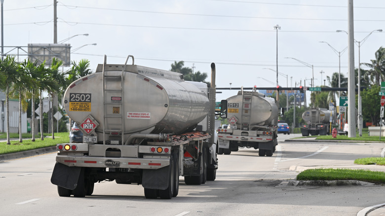 Back view of tanker trucks on the road.