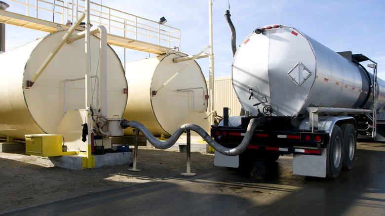Oil tanker attached to fuel drums.