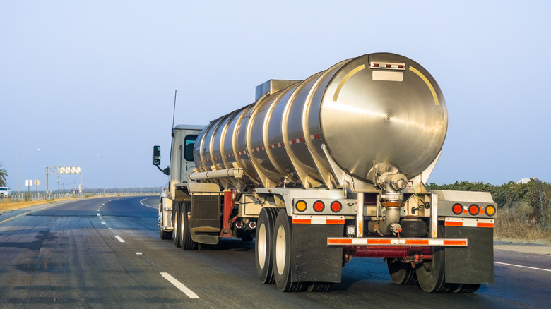 Back view of a tanker truck driving.