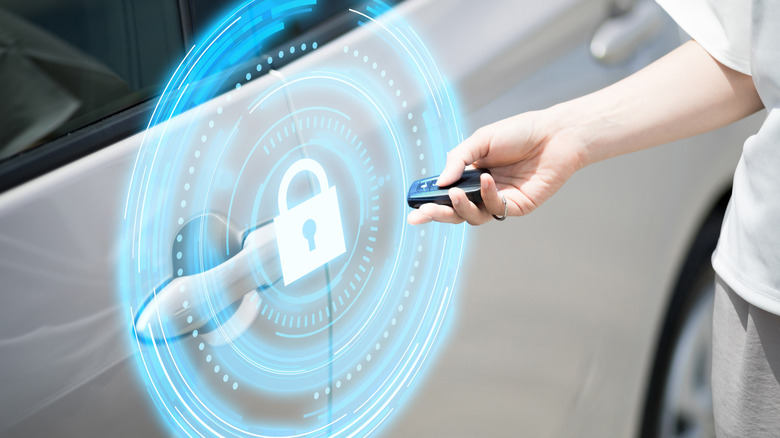 Person using key fob to open car with security