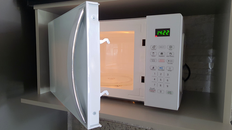 Microwave with door swinging open