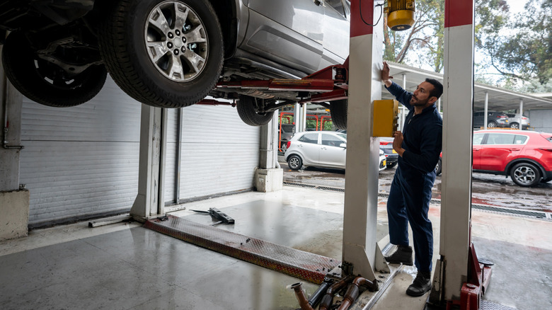 Car being worked on while on lift
