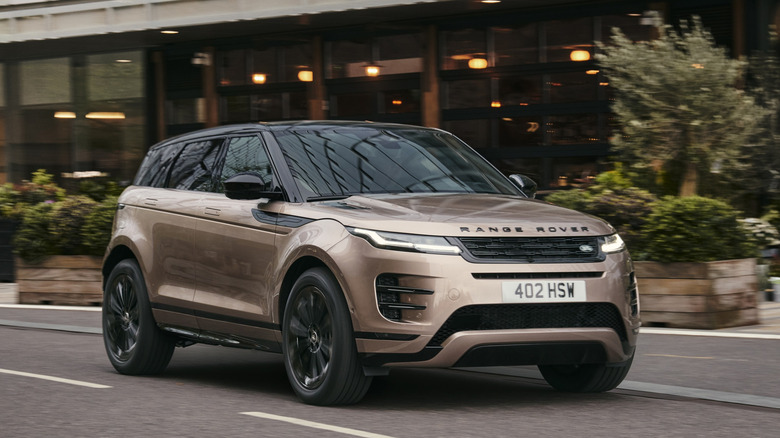 2024 Range Rover Evoque driving on road, front-right 3/4 view
