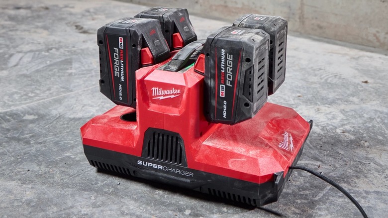 A Milwaukee M18 and M12 Four Bay Simultaneous Super Charger charging four batteries.