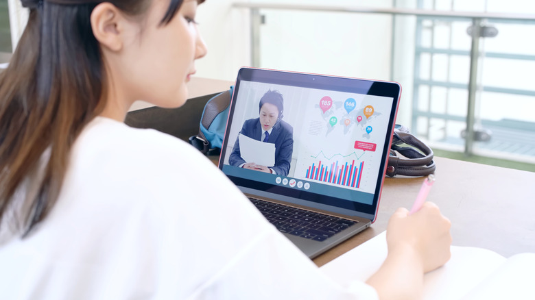 Person in video call on laptop