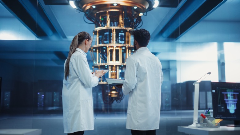 Two scientists standing in front of a quantum computer