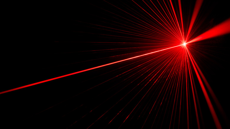 red laser bouncing off wall