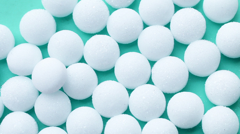 White mothballs against green background