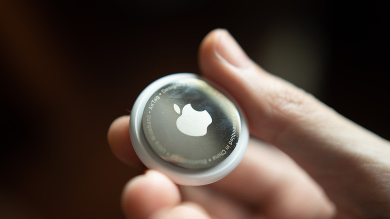 person holding AirTag