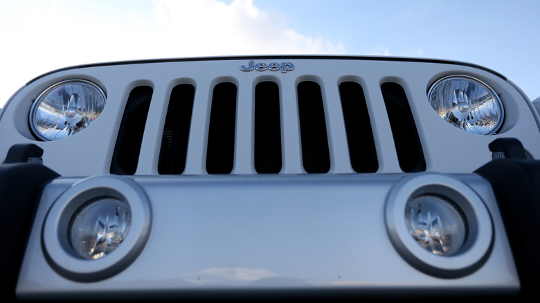 Close-up of a silver Jeep Wrangler grille