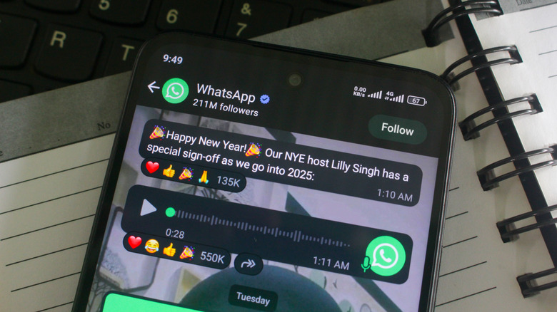 Whatsapp app on phone on top of laptop