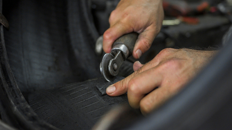 Mechanic installing tire patch