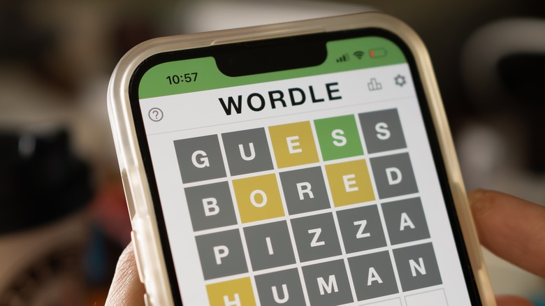 person playing Wordle smartphone
