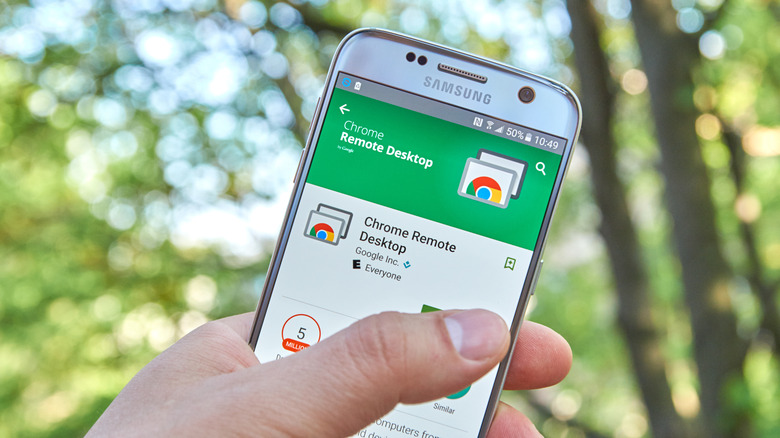Chrome Remote Desktop download page on smartphone outdoors