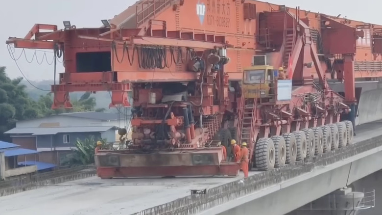 SLJ900/32 on a bridge, several crew members standing next to it