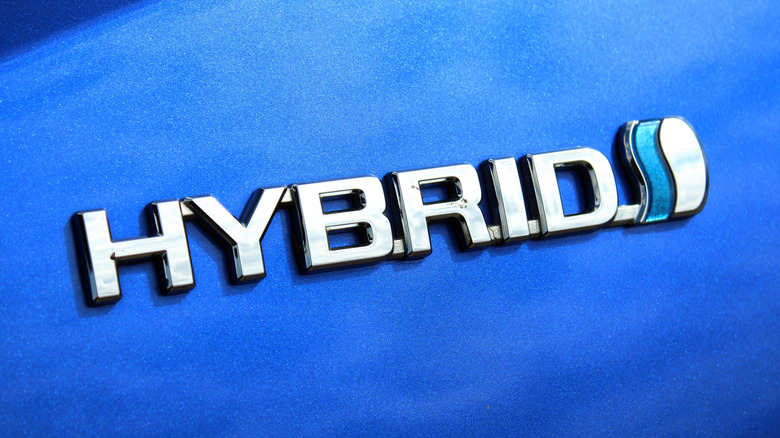 A Hybrid badge on a blue Toyota vehicle.