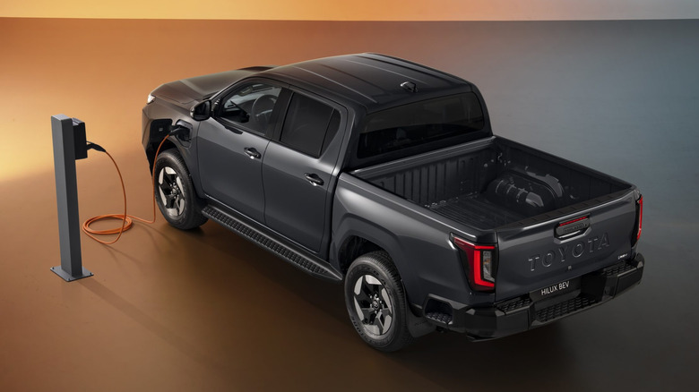 Aerial view of a 2027 Toyota Hilux BEV (Europe-spec) plugged in charging