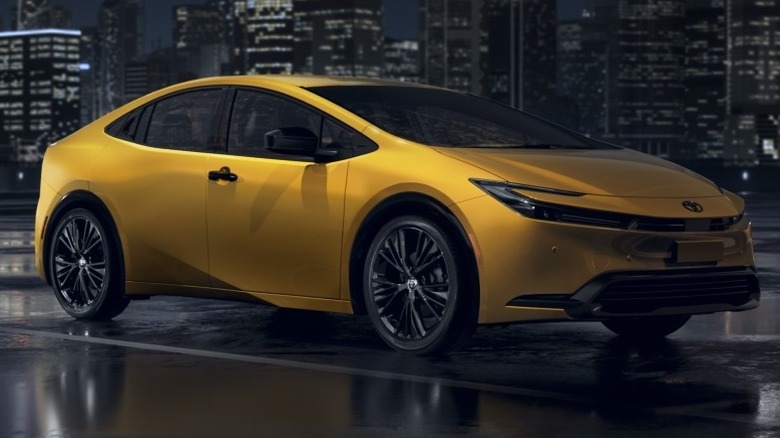 A 2025 Toyota Prius Nightshade parked on a paved surface with buildings in the background.