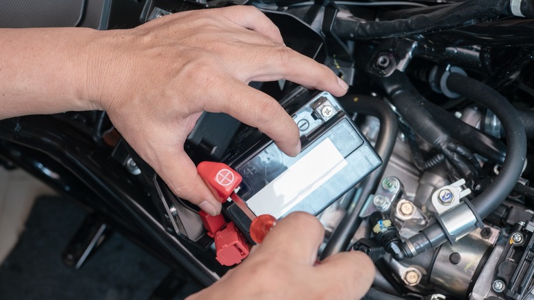 A motorcycle battery receiving maintenance.