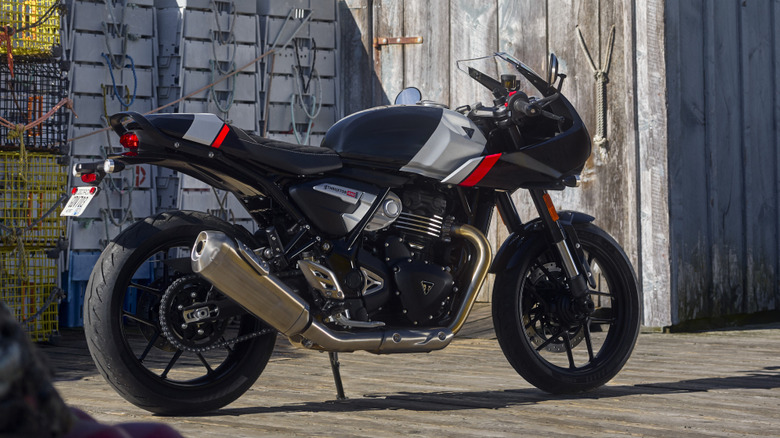 Rear 3/4 view of Triumph Thruxton 400 parked on wooden planks