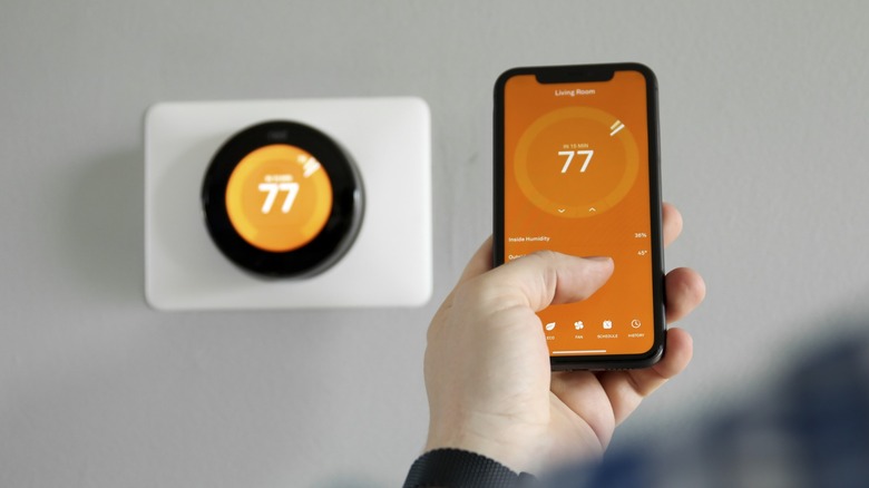 Using a smartphone to control the thermostat.