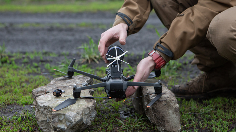 DJI Mavic quadcopter held on the ground.