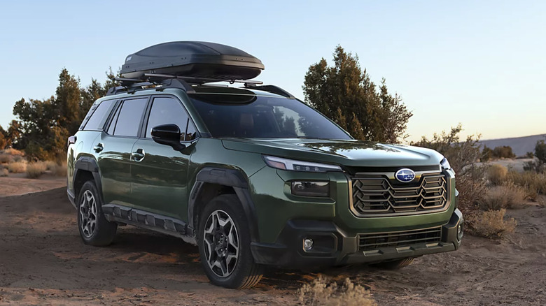 Front right view of green subaru outback parked in desert