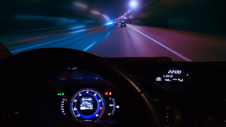 A car speeding with its speedometer visible.