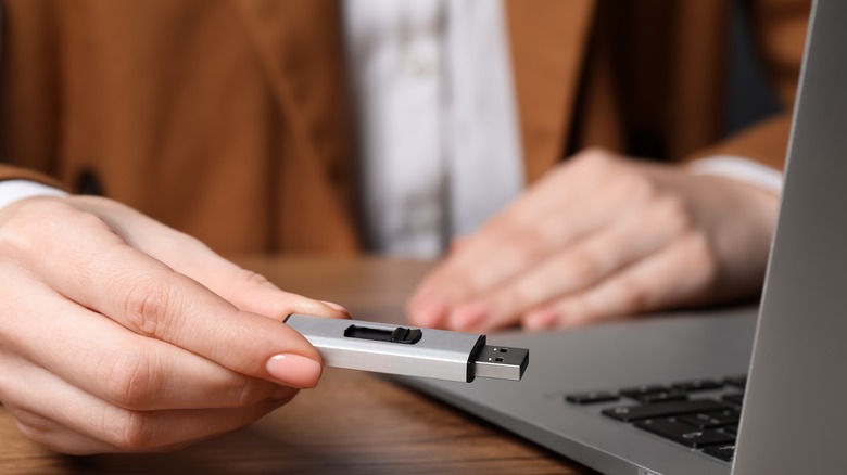 person holding USB drive