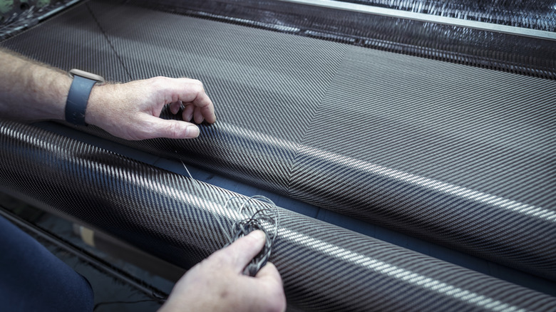 A worker weaving carbon fiber in a mill