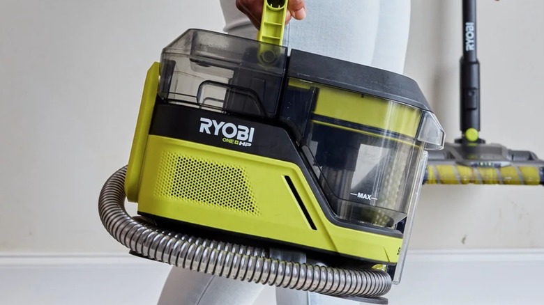 Person carrying Ryobi HP Swiftclean Spot Cleaner