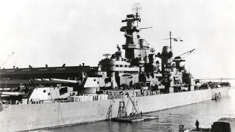 A USS Iowa class battleship at a navy yard.