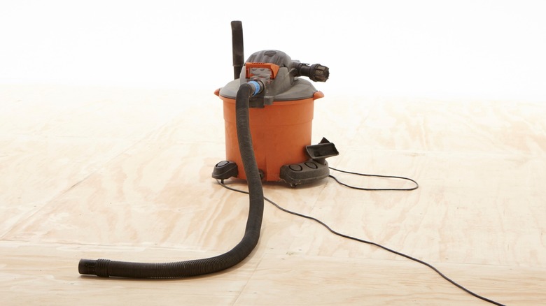 Vacuum cleaner on wooden floor