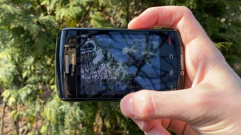 A person using a BlackBerry Storm camera.