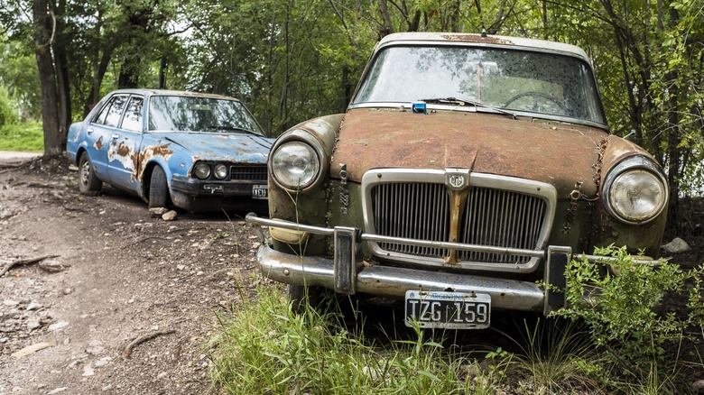 Old and abandoned Honda Civic and MG outside