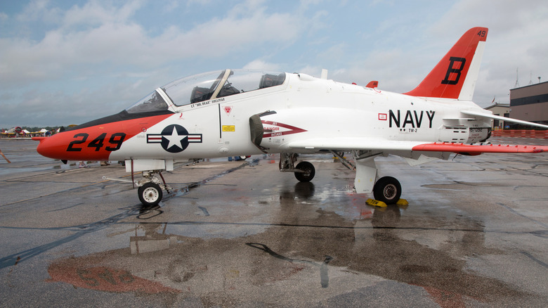 A US Navy T-45 Goshawk training jet on wet tarmac