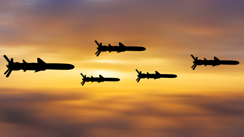 Silhouetted missiles flying in the sky