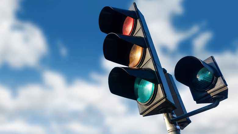A set of traffic signals set against a blue sky